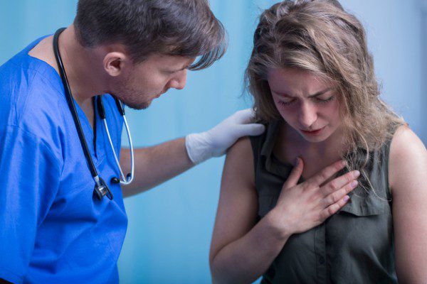 Doctor and woman with chest pain